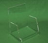 Clear acrylic display stand in front of green background