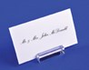 Business card on acrylic mount in front of a blue background